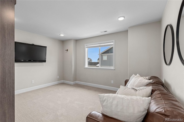 sitting room featuring light carpet