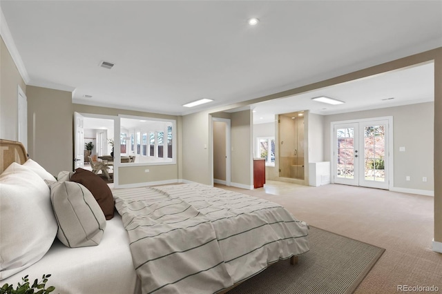 carpeted bedroom featuring ensuite bathroom, ornamental molding, and french doors