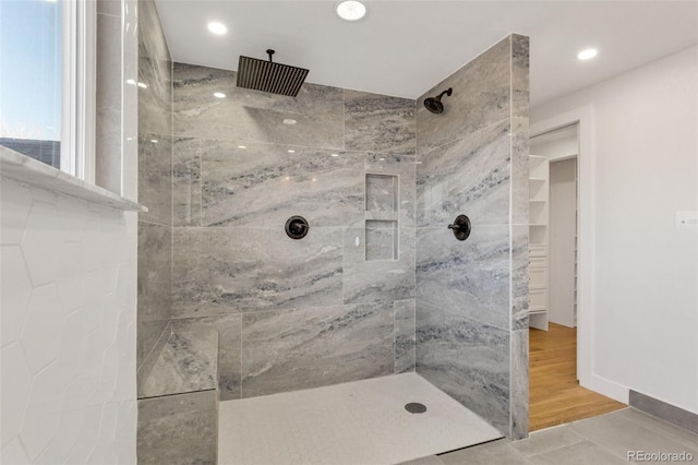 bathroom featuring a tile shower and hardwood / wood-style floors