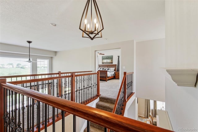 10533 Redcone Way, Highlands Ranch, CO 80130 - corridor with carpet, a chandelier, and an upstairs landing