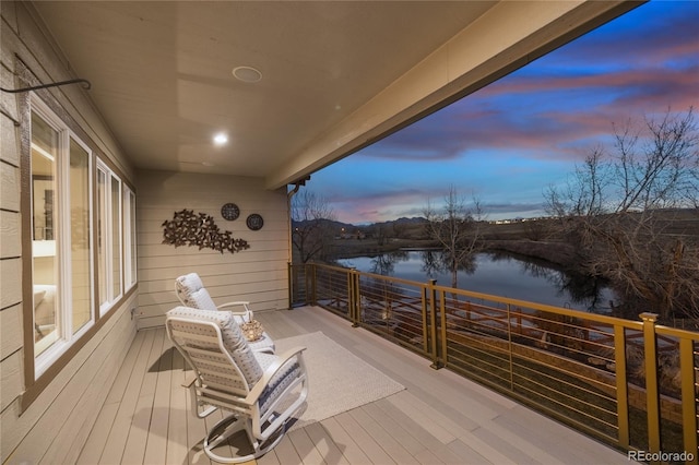 wooden deck featuring a water view