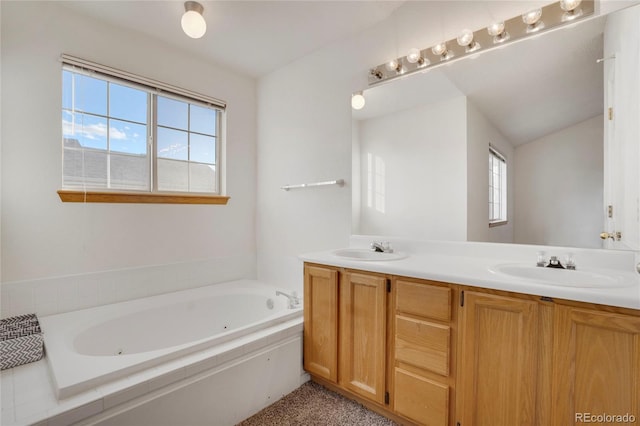 bathroom featuring double vanity, a tub with jets, a sink, and lofted ceiling