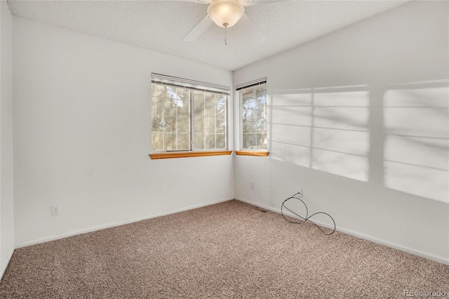 spare room featuring carpet flooring, ceiling fan, a textured ceiling, and baseboards