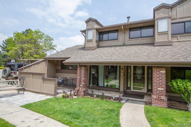 10652 W Florida Ave Unit D, Lakewood, CO 80232 - view of front of house featuring roof with shingles and brick siding
