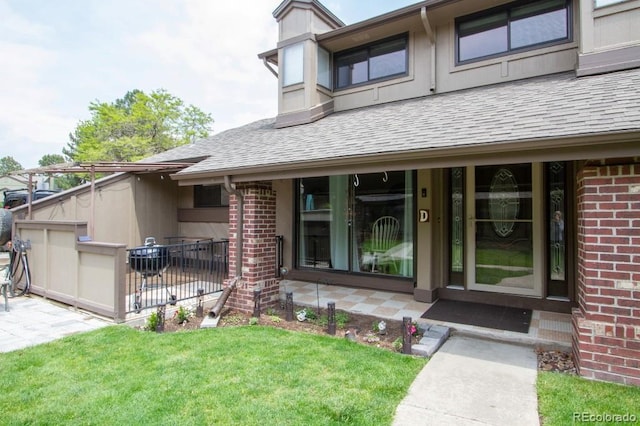 10652 W Florida Ave Unit D, Lakewood, CO 80232 - view of exterior entry with brick siding and roof with shingles