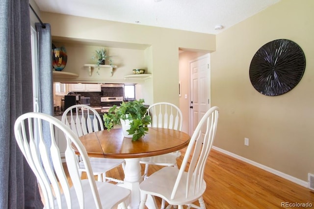 10652 W Florida Ave Unit D, Lakewood, CO 80232 - dining room featuring light wood-style floors and baseboards