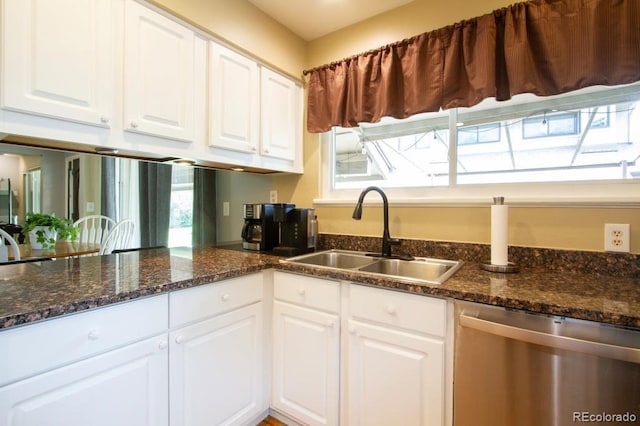 10652 W Florida Ave Unit D, Lakewood, CO 80232 - kitchen with stainless steel dishwasher, white cabinets, and dark stone counters