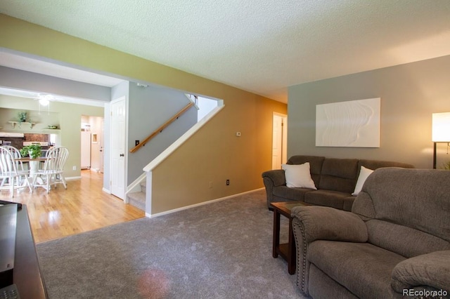 10652 W Florida Ave Unit D, Lakewood, CO 80232 - living area with stairs, carpet, a ceiling fan, and a textured ceiling