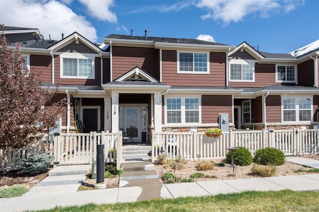 119 Jackson Dr, Erie, CO 80516 - view of property featuring fence and stone siding