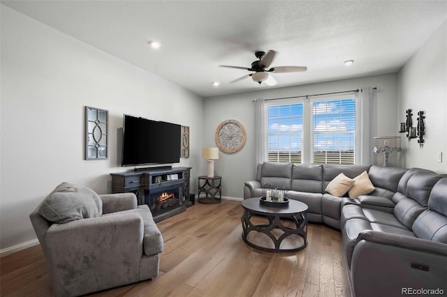 119 Jackson Dr, Erie, CO 80516 - living area featuring wood finished floors, ceiling fan, a lit fireplace, baseboards, and recessed lighting