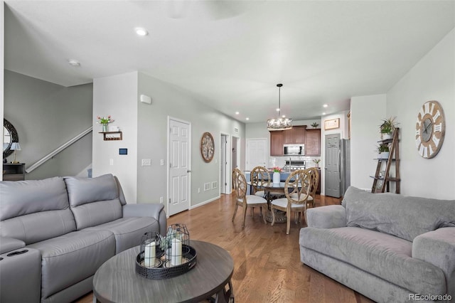 119 Jackson Dr, Erie, CO 80516 - living area with a chandelier, wood finished floors, visible vents, and recessed lighting