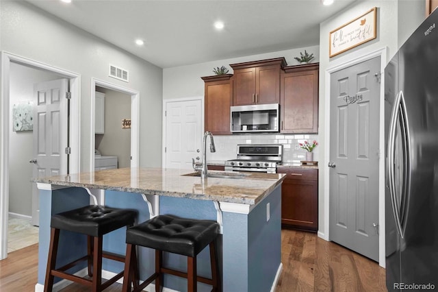 119 Jackson Dr, Erie, CO 80516 - kitchen featuring a sink, dark wood-style flooring, visible vents, recessed lighting, and appliances with stainless steel finishes