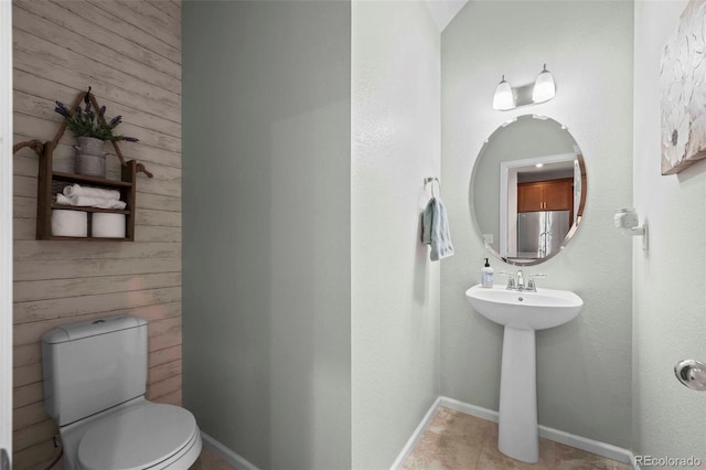 119 Jackson Dr, Erie, CO 80516 - bathroom featuring wood walls, a sink, and toilet