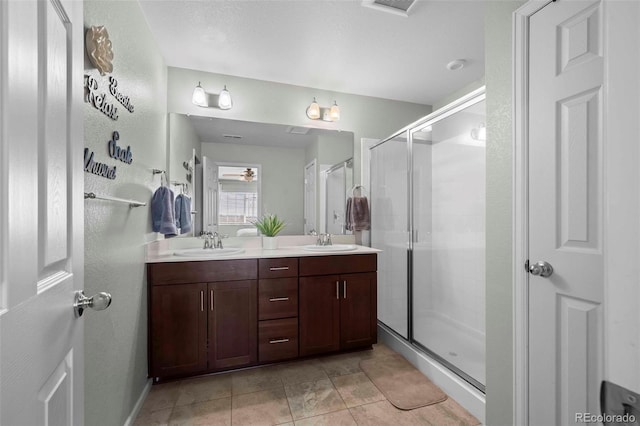 119 Jackson Dr, Erie, CO 80516 - full bathroom featuring double vanity, a shower stall, tile patterned flooring, and a sink