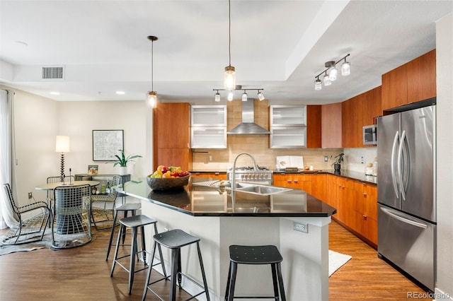 2240 N Clay St Unit 309, Denver, CO 80211 - kitchen featuring appliances with stainless steel finishes, wall chimney exhaust hood, modern cabinets, brown cabinets, and recessed lighting