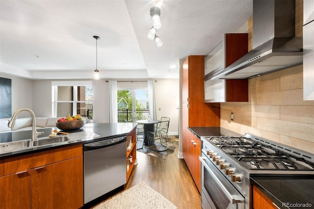 2240 N Clay St Unit 309, Denver, CO 80211 - kitchen featuring appliances with stainless steel finishes, wall chimney exhaust hood, dark wood-style floors, and brown cabinetry