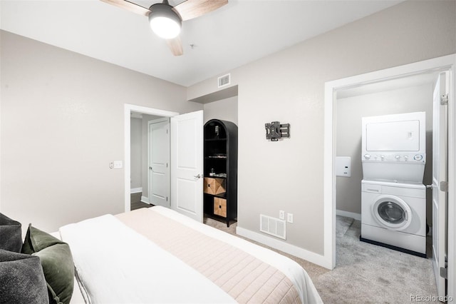 2240 N Clay St Unit 309, Denver, CO 80211 - carpeted bedroom featuring stacked washer and clothes dryer and ceiling fan