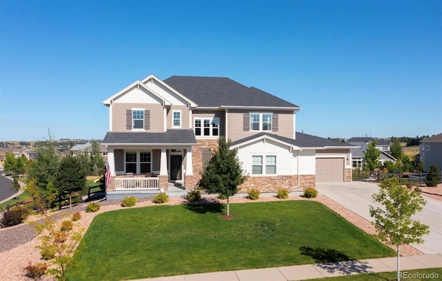 craftsman inspired home with a garage, driveway, stone siding, covered porch, and a front lawn