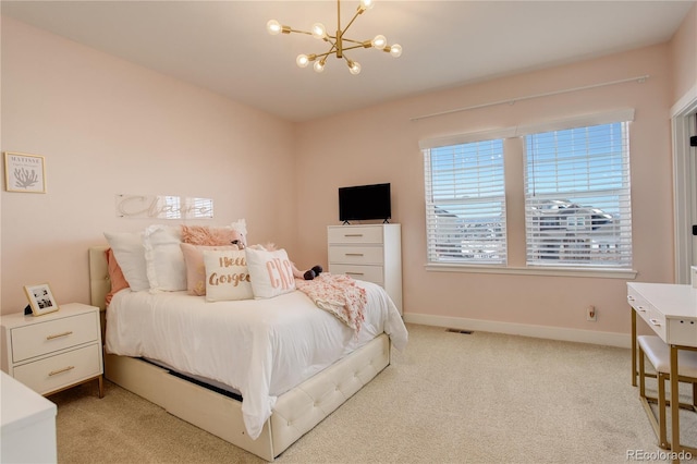 carpeted bedroom with baseboards and a notable chandelier