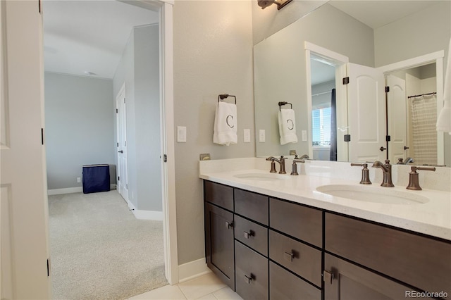 bathroom featuring a sink, baseboards, and double vanity