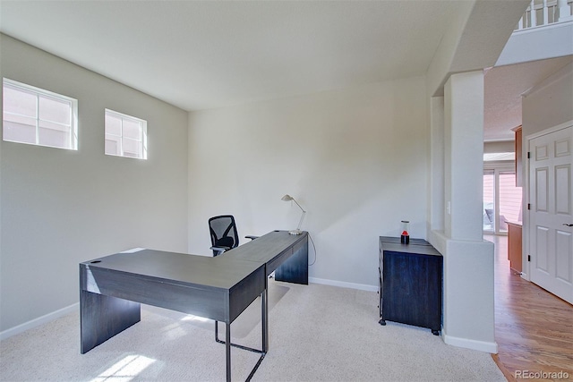 carpeted office space featuring baseboards