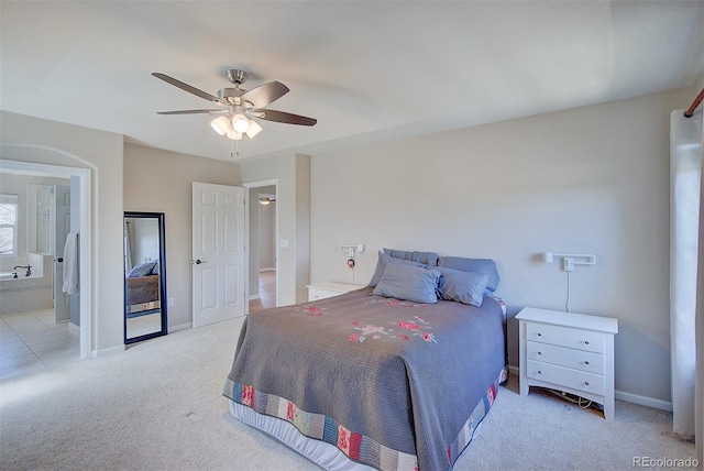 bedroom with connected bathroom, baseboards, a ceiling fan, and carpet flooring