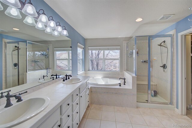 bathroom featuring tile patterned floors, a sink, and plenty of natural light
