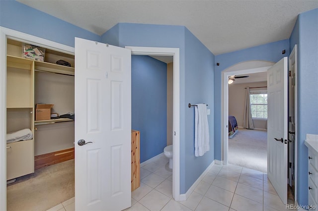 interior space with baseboards, light tile patterned floors, and light colored carpet