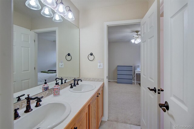 ensuite bathroom featuring ceiling fan, ensuite bathroom, a sink, and double vanity