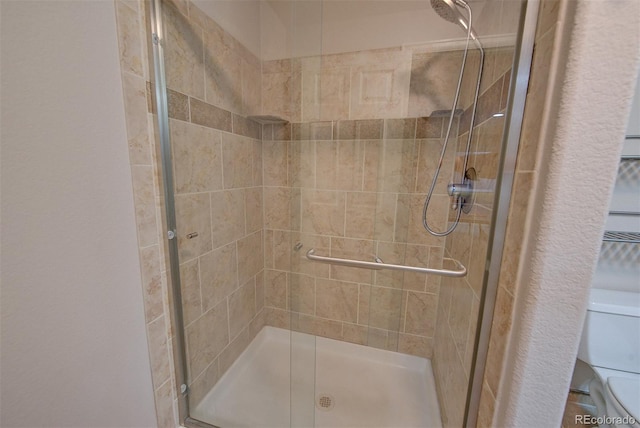 full bath with toilet and a stall shower