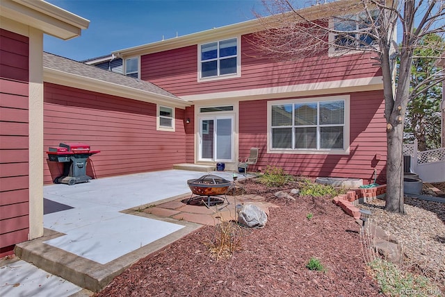 back of house featuring a patio area and an outdoor fire pit