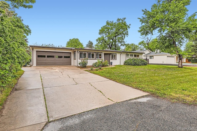 845 Everett St, Lakewood, CO 80215 - ranch-style home with a garage, a front yard, driveway, and stucco siding