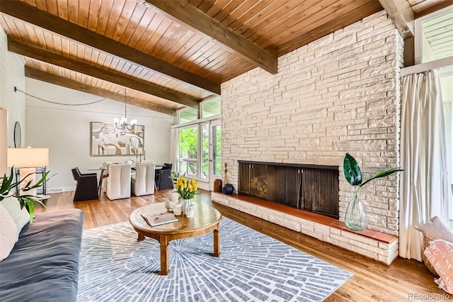 845 Everett St, Lakewood, CO 80215 - living area with wooden ceiling, wood finished floors, a stone fireplace, and a chandelier