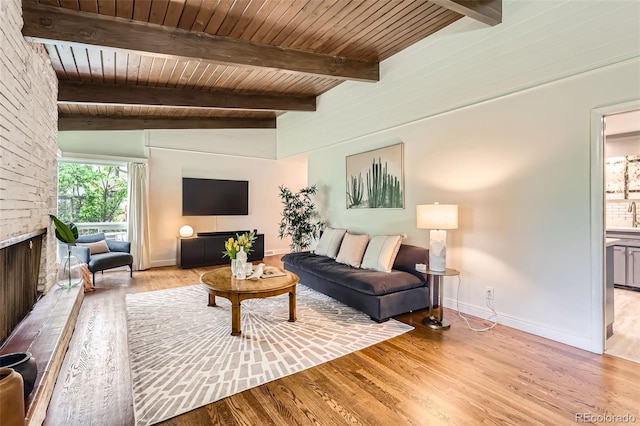 845 Everett St, Lakewood, CO 80215 - living area featuring light wood-style floors, wooden ceiling, baseboards, and a fireplace