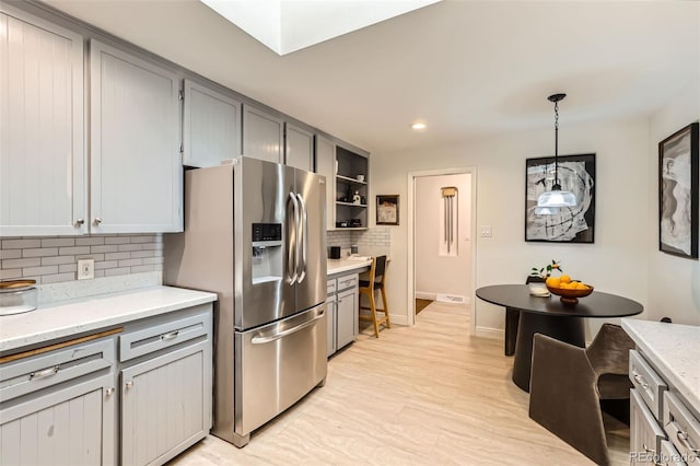 845 Everett St, Lakewood, CO 80215 - kitchen with stainless steel fridge, gray cabinets, tasteful backsplash, pendant lighting, and recessed lighting