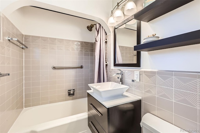 845 Everett St, Lakewood, CO 80215 - bathroom with shower / tub combo with curtain, vanity, toilet, and tile walls