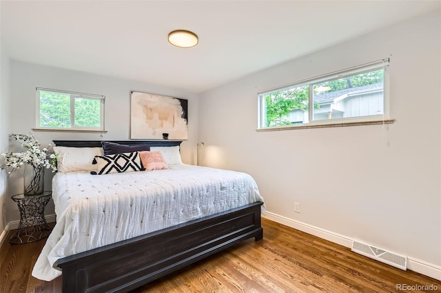 845 Everett St, Lakewood, CO 80215 - bedroom featuring baseboards, multiple windows, and wood finished floors