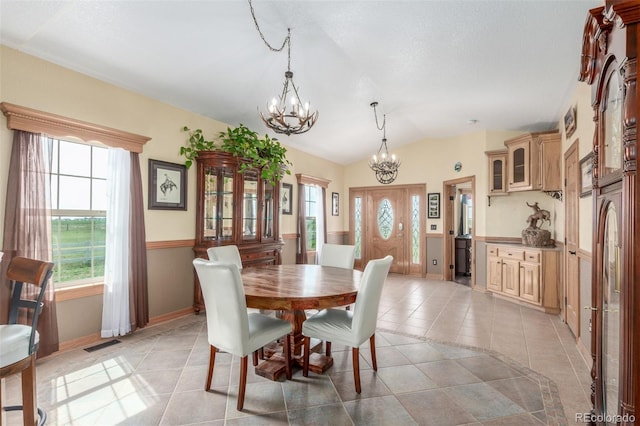 46303 E 106th Ave, Bennett, CO 80102 - dining room featuring a chandelier, light tile patterned floors, lofted ceiling, and baseboards