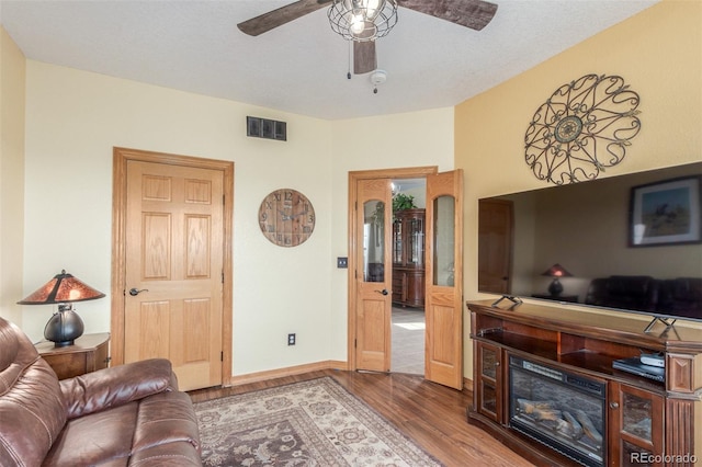 46303 E 106th Ave, Bennett, CO 80102 - living area with wood finished floors, ceiling fan, and baseboards
