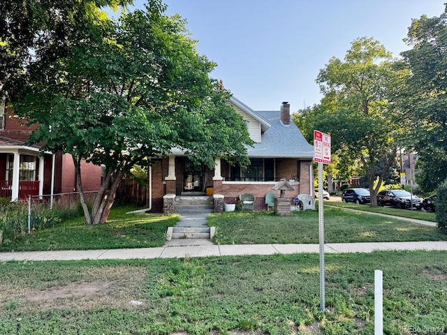 1731 E 25th Ave, Denver, CO 80205 - view of front of home featuring brick siding and a chimney