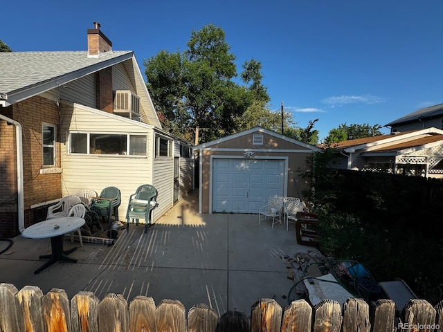 1731 E 25th Ave, Denver, CO 80205 - view of side of home featuring an outdoor structure, a chimney, driveway, brick siding, and a garage