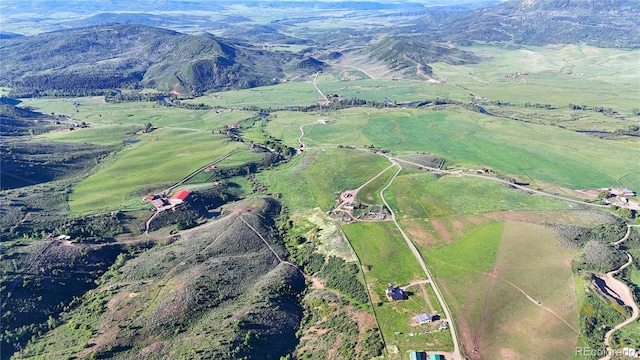 26000 Wheeler Creek Ln, Steamboat Springs, CO 80487 - aerial view of property and surrounding area featuring rural landscape and a mountainous background