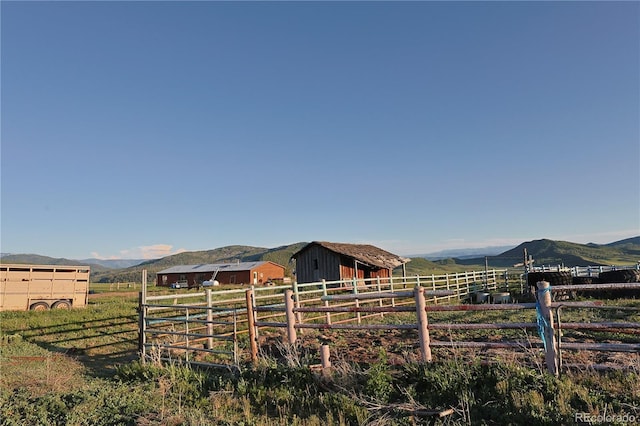 26000 Wheeler Creek Ln, Steamboat Springs, CO 80487 - view of yard featuring a rural view, a mountain view, an outdoor structure, and an exterior structure