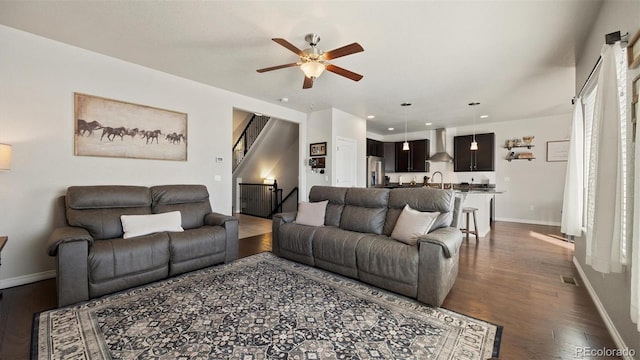 living room with ceiling fan and dark hardwood / wood-style flooring