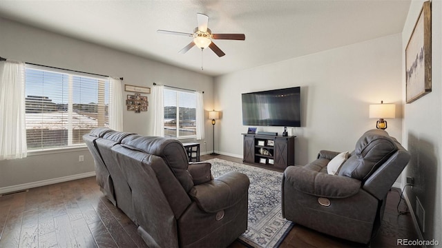 living room featuring ceiling fan and dark wood-type flooring