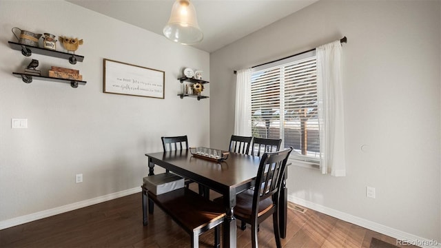 dining area featuring dark hardwood / wood-style floors