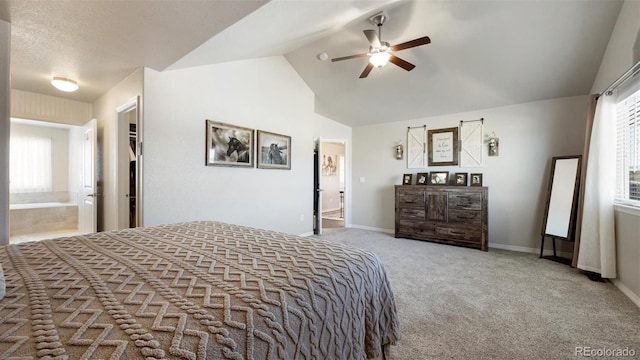 carpeted bedroom featuring connected bathroom, ceiling fan, a spacious closet, lofted ceiling, and a closet