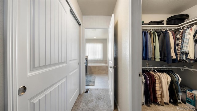 spacious closet featuring light tile patterned flooring