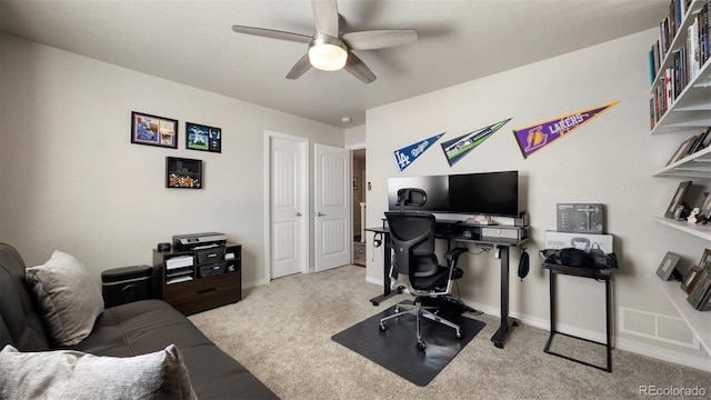 office area featuring light carpet and ceiling fan