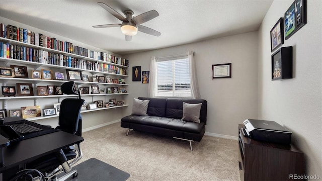 home office featuring light carpet and ceiling fan